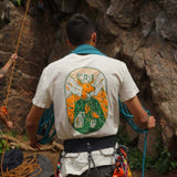A climber wearing the deer t-shirt while coiling a rope outside